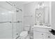 Clean bathroom with glass shower door, tile floors, and framed mirror at 1450 Chadberry Way, Lawrenceville, GA 30043