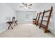 Bright bedroom featuring a desk and ladder shelf under a ceiling fan at 1450 Chadberry Way, Lawrenceville, GA 30043