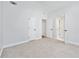 Spacious bedroom featuring neutral carpeting and multiple closet doors at 1450 Chadberry Way, Lawrenceville, GA 30043
