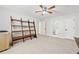 Spacious bedroom with a ladder shelf, ceiling fan, and access to bathroom at 1450 Chadberry Way, Lawrenceville, GA 30043