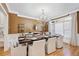 Elegant dining room with a long dark wood table, chandelier, and natural light at 1450 Chadberry Way, Lawrenceville, GA 30043