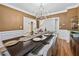 Formal dining room featuring a classic chandelier, trim detail, and hardwood floors at 1450 Chadberry Way, Lawrenceville, GA 30043