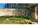 Stone entrance sign for Chadwick Lakes community surrounded by colorful flowers and lush greenery at 1450 Chadberry Way, Lawrenceville, GA 30043