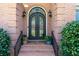 Close-up of the elegant arched double front door with ornate ironwork and brick surround at 1450 Chadberry Way, Lawrenceville, GA 30043
