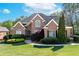 Stunning brick home boasts manicured lawn, walkway, and well-maintained landscaping at 1450 Chadberry Way, Lawrenceville, GA 30043