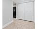 Hallway featuring tile flooring and convenient closet space with a black refrigerator in the background at 1450 Chadberry Way, Lawrenceville, GA 30043