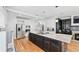 Gourmet kitchen with a center island, stainless steel appliances, and custom cabinetry and adjoining bar and fireplace at 1450 Chadberry Way, Lawrenceville, GA 30043