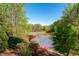 Scenic lake view surrounded by lush greenery and colorful flowers, offering a tranquil and picturesque setting at 1450 Chadberry Way, Lawrenceville, GA 30043