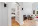 Open living space with hardwood floors, archway, built-in shelves and view into the main bedroom at 1450 Chadberry Way, Lawrenceville, GA 30043