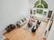 Bright, two-story living room showcasing large windows, hardwood floors, and comfortable seating area at 1450 Chadberry Way, Lawrenceville, GA 30043