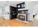 Living room with fireplace, custom shelving, and adjacent breakfast bar with plenty of natural light at 1450 Chadberry Way, Lawrenceville, GA 30043