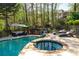Sparkling pool and spa area with comfortable lounge chairs, ideal for outdoor relaxation and entertaining guests at 1450 Chadberry Way, Lawrenceville, GA 30043