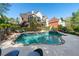 Impressive backyard with a luxurious pool, spa, lush landscaping, and stylish outdoor seating for entertainment at 1450 Chadberry Way, Lawrenceville, GA 30043