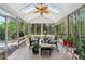 Cozy sunroom filled with natural light, featuring comfortable seating and lush greenery at 1450 Chadberry Way, Lawrenceville, GA 30043