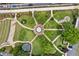 Overhead view of a beautifully designed park with winding walkways, a central fountain, mature trees, and inviting green spaces at 207 Magnolia Creek Way, Woodstock, GA 30188