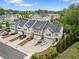 Townhome exteriors featuring multiple stories, covered entries, attached garages and complemented by landscaping and green lawns at 207 Magnolia Creek Way, Woodstock, GA 30188