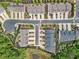 Aerial view of townhomes with manicured landscaping and neighborhood street access at 207 Magnolia Creek Way, Woodstock, GA 30188