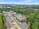 Aerial view of townhomes near lush green space and mature trees in a walkable community at 207 Magnolia Creek Way, Woodstock, GA 30188