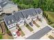 Charming townhomes with attached garages and well-manicured lawns surrounded by mature trees and lush landscaping at 207 Magnolia Creek Way, Woodstock, GA 30188