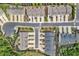 Bird's-eye view of a neighborhood featuring townhomes, manicured landscaping, and street parking at 207 Magnolia Creek Way, Woodstock, GA 30188