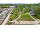 Stunning aerial perspective of a park showcasing lush lawns, winding paths, a central fountain, gazebo and mature trees at 207 Magnolia Creek Way, Woodstock, GA 30188