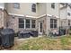 Backyard featuring a stone patio, outdoor seating, a grill, and a small lawn area at 207 Magnolia Creek Way, Woodstock, GA 30188