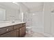 Bathroom with a marble sink top, dark wood cabinets, tiled floors, a white toilet and a shower/tub at 207 Magnolia Creek Way, Woodstock, GA 30188