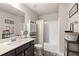 Bathroom featuring a dark vanity with a white countertop, modern fixtures, and a shower/tub combo at 207 Magnolia Creek Way, Woodstock, GA 30188