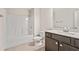 Bathroom with neutral-toned flooring, a white sink and toilet, and a white shower-tub combo at 207 Magnolia Creek Way, Woodstock, GA 30188
