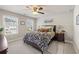 Cozy bedroom with two windows providing natural light, ceiling fan, and modern decor at 207 Magnolia Creek Way, Woodstock, GA 30188