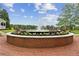 Beautiful community fountain surrounded by flowers and a brick plaza at 207 Magnolia Creek Way, Woodstock, GA 30188
