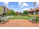 Community green space with seating and vintage buildings at 207 Magnolia Creek Way, Woodstock, GA 30188