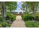 Beautiful community path with manicured shrubs and flowers, leading to a fountain at 207 Magnolia Creek Way, Woodstock, GA 30188