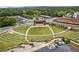 Scenic aerial view showcasing a vibrant community park with tiered seating, a central stage, parking, and lush greenery at 207 Magnolia Creek Way, Woodstock, GA 30188