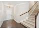 Bright entryway featuring hardwood floors, a stylish chandelier, and a staircase with wooden banister at 207 Magnolia Creek Way, Woodstock, GA 30188
