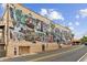 A mural on the side of a commercial building showing scenes from everyday life in this small town at 207 Magnolia Creek Way, Woodstock, GA 30188