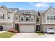 Charming townhome with a two-car garage, lovely landscaping, and inviting curb appeal at 207 Magnolia Creek Way, Woodstock, GA 30188