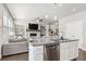 Bright kitchen open to living area with large island, stainless appliances, and modern finishes at 207 Magnolia Creek Way, Woodstock, GA 30188
