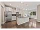 Modern kitchen with stainless steel appliances, granite countertops, and a large island with a breakfast bar at 207 Magnolia Creek Way, Woodstock, GA 30188
