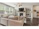 Comfortable living room featuring a fireplace, built-in shelving, and abundant natural light at 207 Magnolia Creek Way, Woodstock, GA 30188