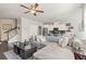 Open-concept living area with hardwood floors, a modern staircase, and seamless flow to the kitchen at 207 Magnolia Creek Way, Woodstock, GA 30188