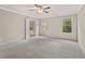 Spacious bedroom with carpet, ceiling fan and two windows overlooking the greenery at 207 Magnolia Creek Way, Woodstock, GA 30188