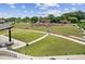 Overhead shot of an outdoor amphitheater boasting tiered seating, a spacious green lawn, stage, and surrounding lush landscape at 207 Magnolia Creek Way, Woodstock, GA 30188