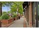 This street view shows a brick building with shops and sidewalks and has benches and vegetation at 207 Magnolia Creek Way, Woodstock, GA 30188