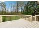 A raised back deck overlooks a private backyard filled with mature trees and landscaping at 392 Beranda Cir, Douglasville, GA 30134
