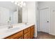 Bathroom showcasing a double sink vanity, a large mirror, and wood cabinets at 392 Beranda Cir, Douglasville, GA 30134