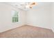 Well-lit bedroom with neutral carpet, a ceiling fan, and large window for natural light at 392 Beranda Cir, Douglasville, GA 30134
