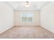 Bright bedroom with neutral carpeting, tray ceiling and a ceiling fan for added comfort at 392 Beranda Cir, Douglasville, GA 30134
