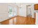 Bright dining area with hardwood floors and large windows offering natural light and access to the back patio at 392 Beranda Cir, Douglasville, GA 30134