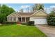 Charming single-story home with a well-manicured lawn, beautiful landscaping, and an attached two-car garage at 392 Beranda Cir, Douglasville, GA 30134